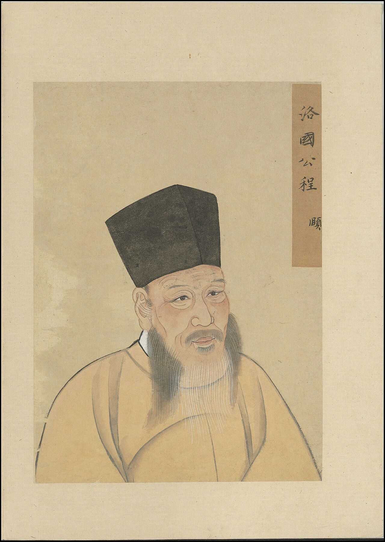 Painted bust of an elderly man with a long grey beard, in a tall black cap and a pale robe