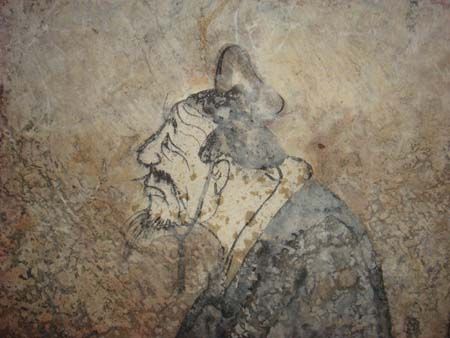 Faded ink wall painting of a bearded man in profile wearing a tall cap
