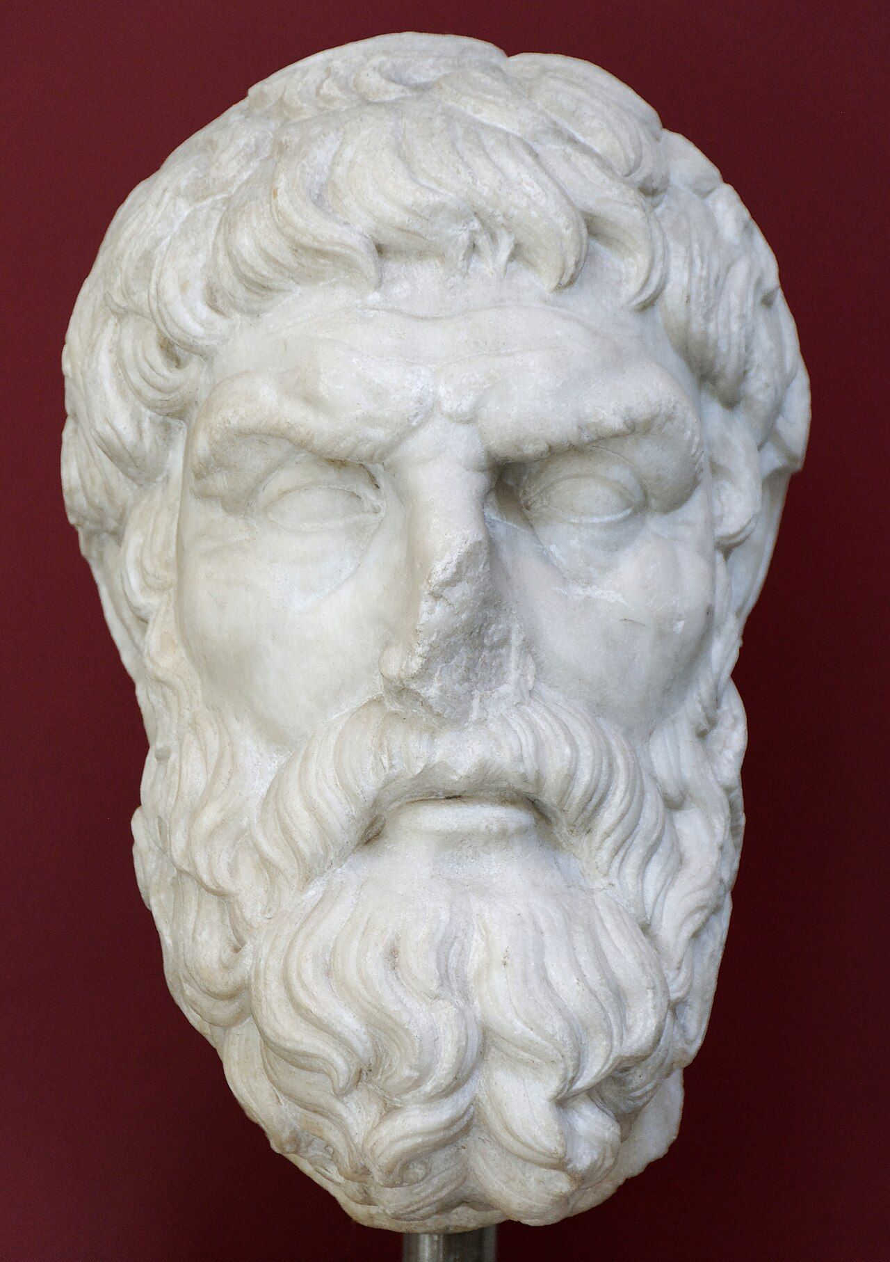 White marble head of a bearded man with a lined forehead