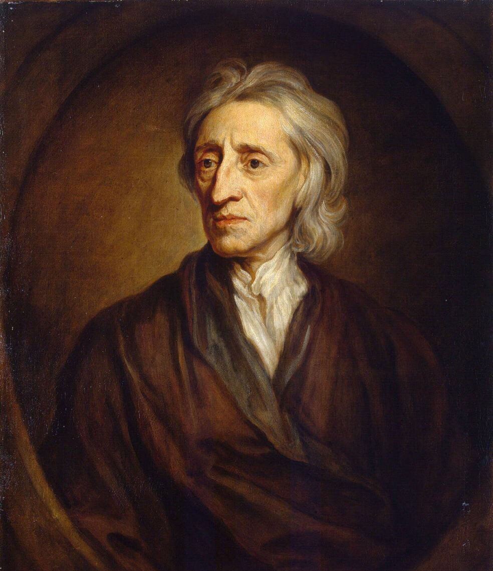 Portrait of an older man with long grey hair and a hollow-cheeked face, in a dark coat