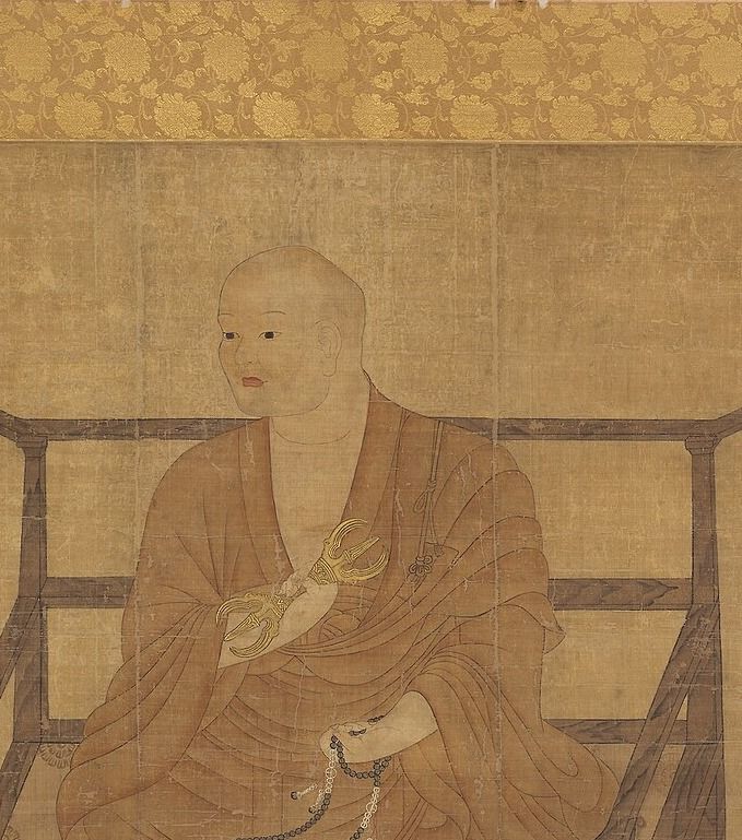 Painted portrait of a monk with a shaven head in an ochre robe, seated in a chair and holding a ritual vajra and prayer beads