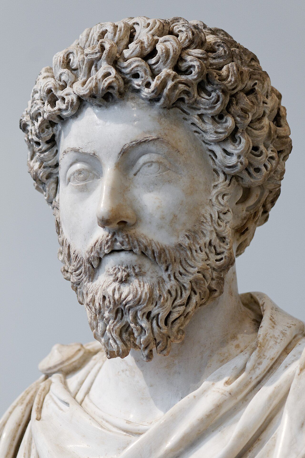 Marble bust of a man with thick curly hair and a full beard