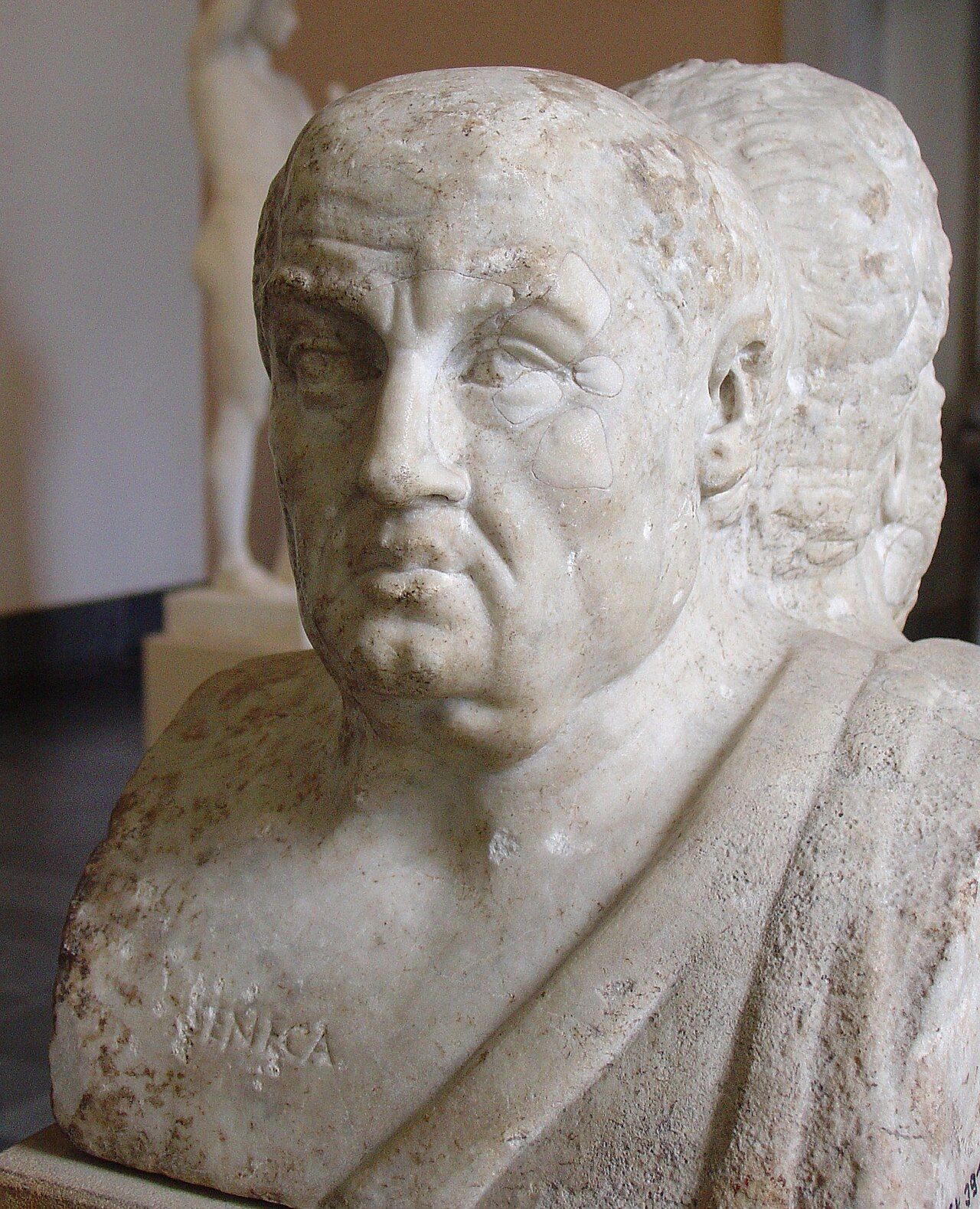 Marble bust of a heavy-featured, balding man, joined back to back with another head
