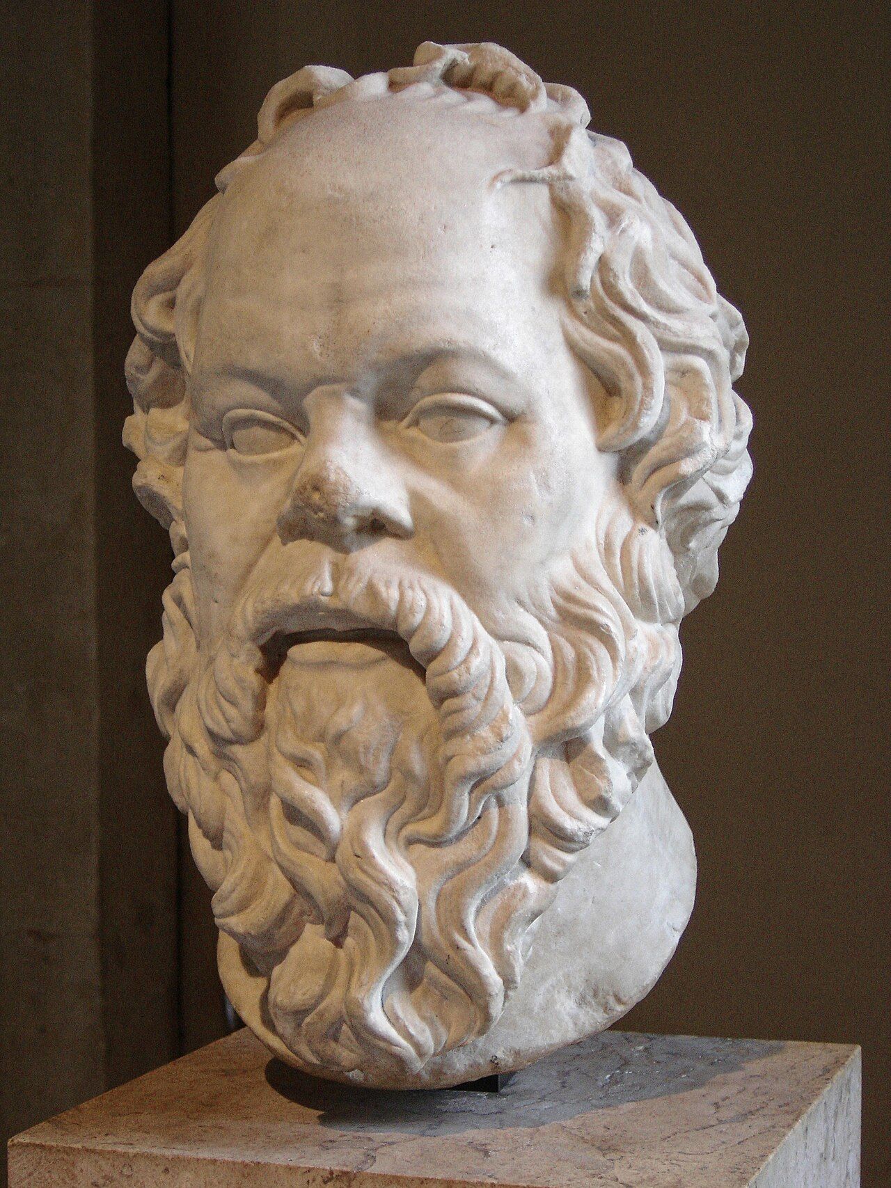 Marble bust of a balding, bearded man with a broad, snub nose